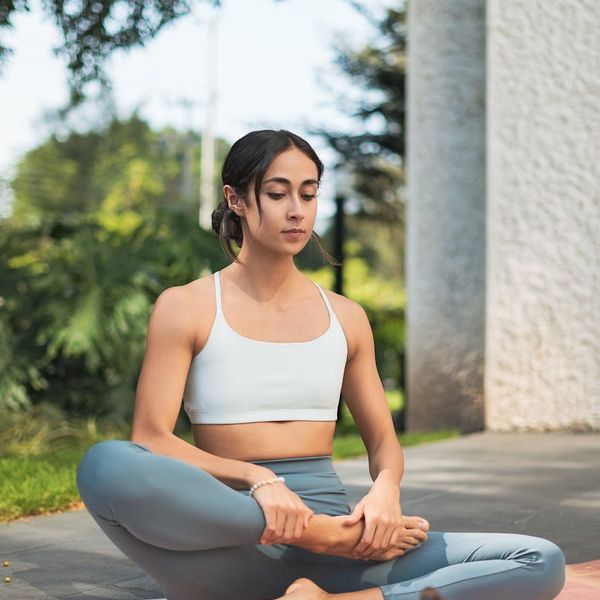 Person meditating peacefully in a tranquil natural setting.